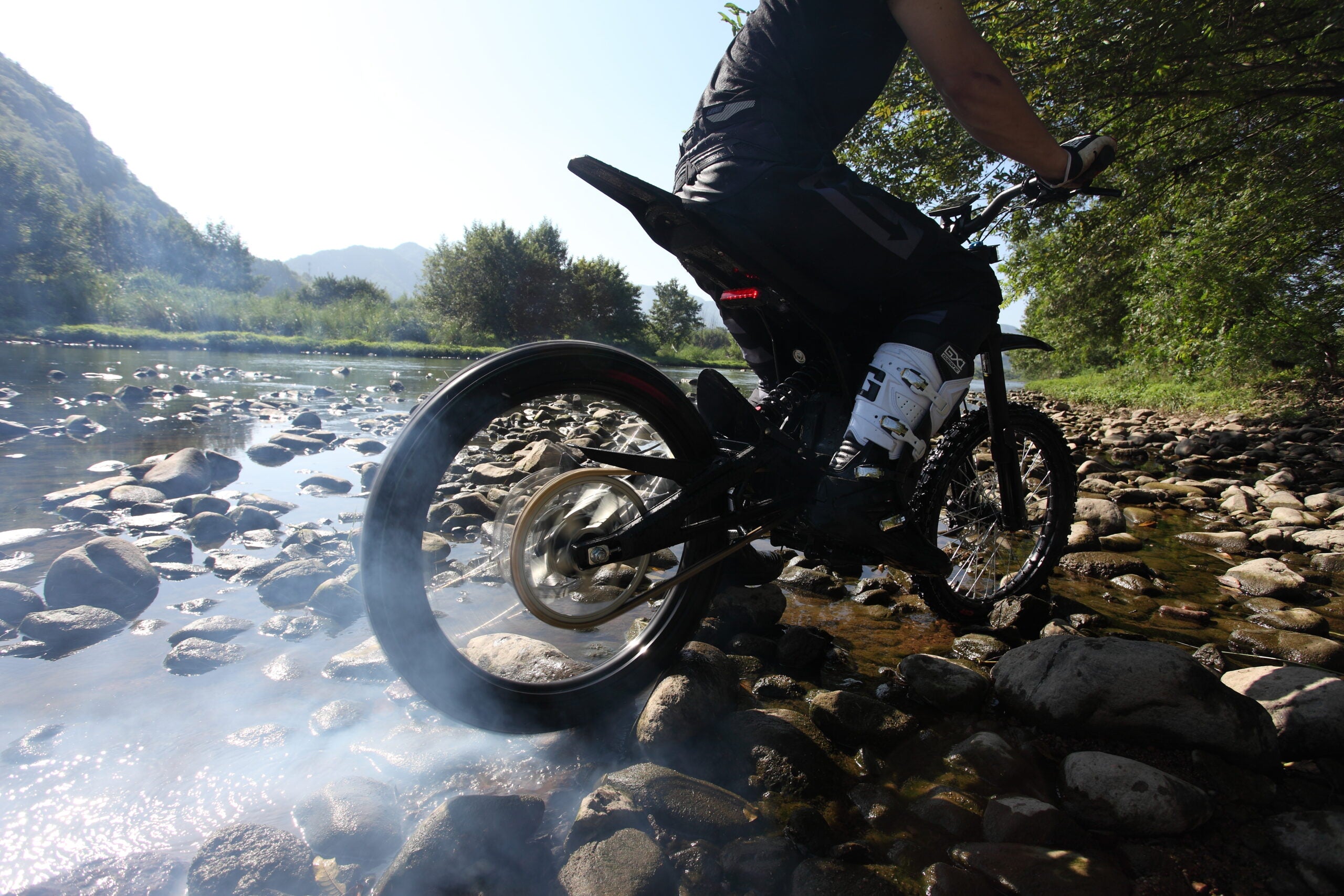 Man taking the E-Ride Pro S across a small lake